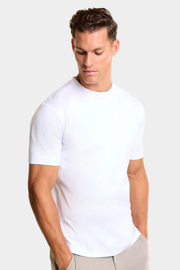 Man wearing a plain white t-shirt against a light background